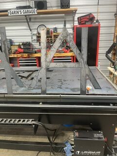 Custom metal fabrication in progress on a CNC plasma cutting table at Darin's Unique Designs